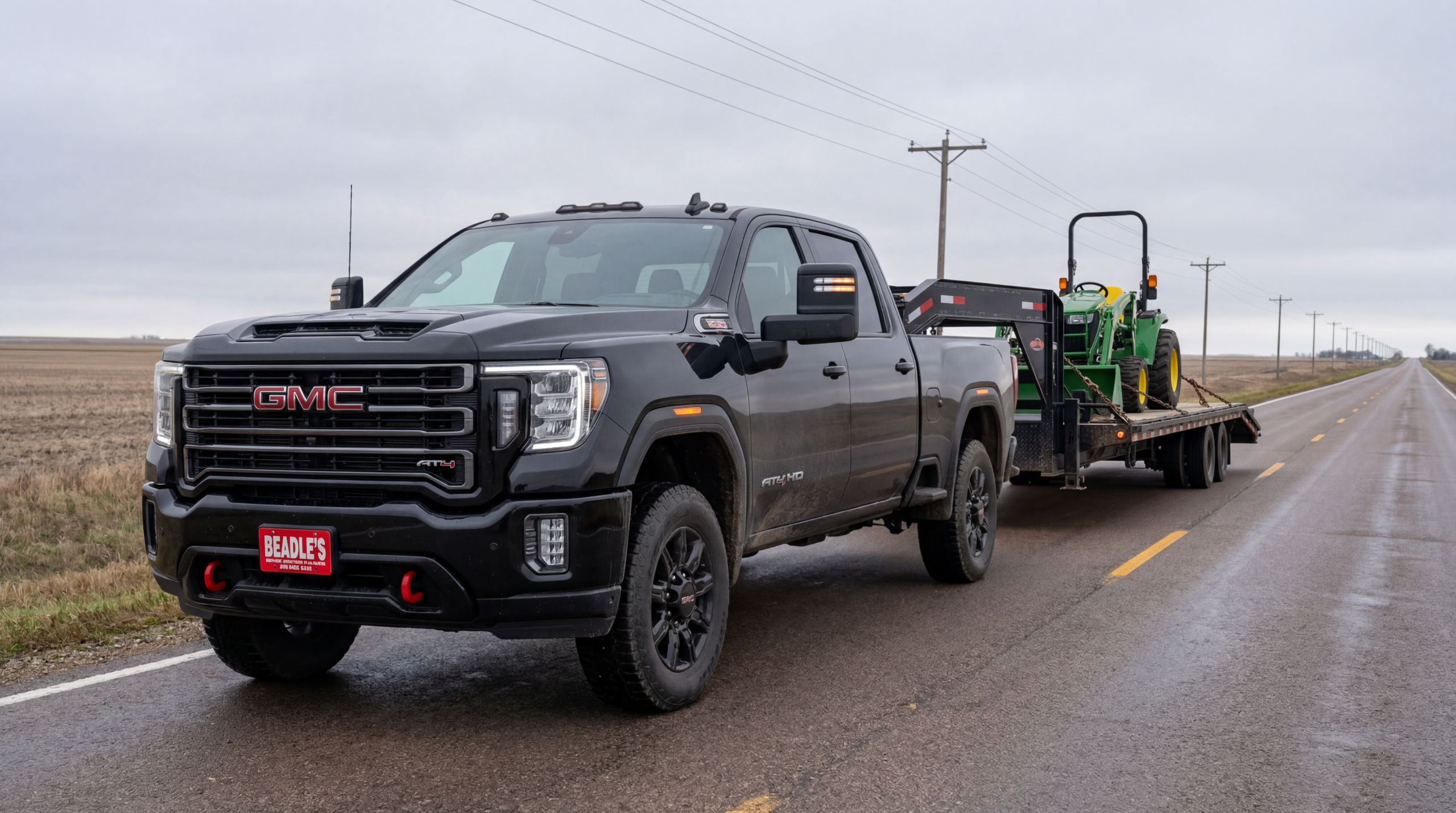 2026 GMC Sierra 2500HD AT4 towing equipment trailer on South Dakota highway