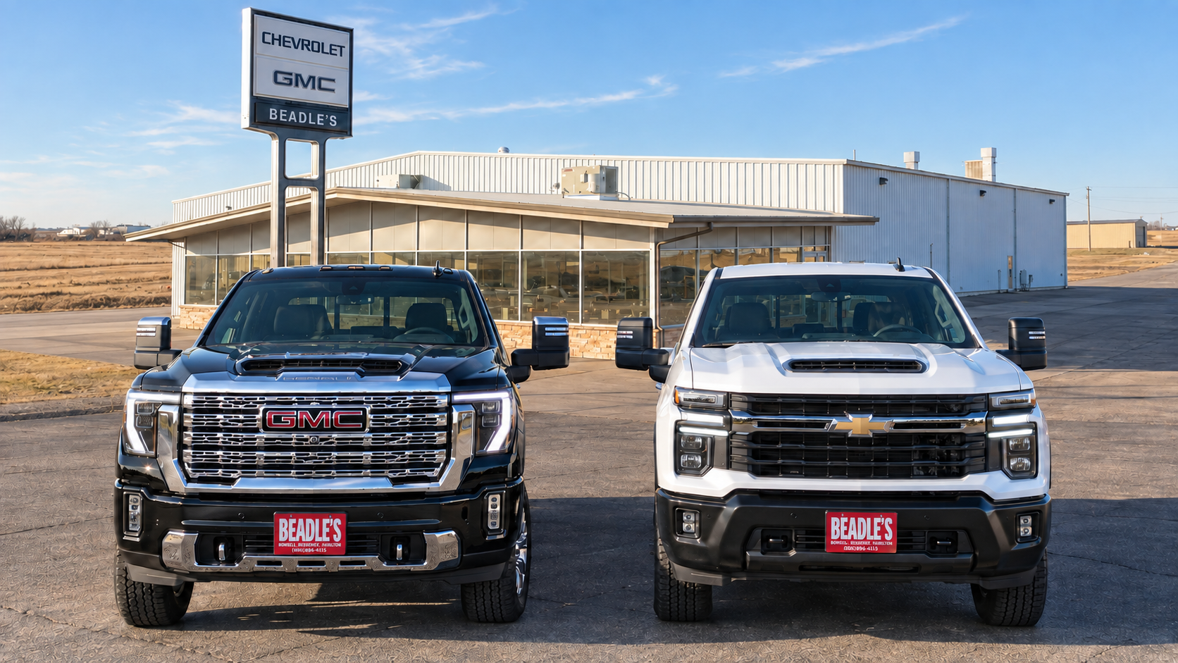 2026 GMC Sierra 2500 HD Denali parked beside a Chevrolet Silverado 2500 HD on the lot at Beadle Chevrolet GMC in Mobridge