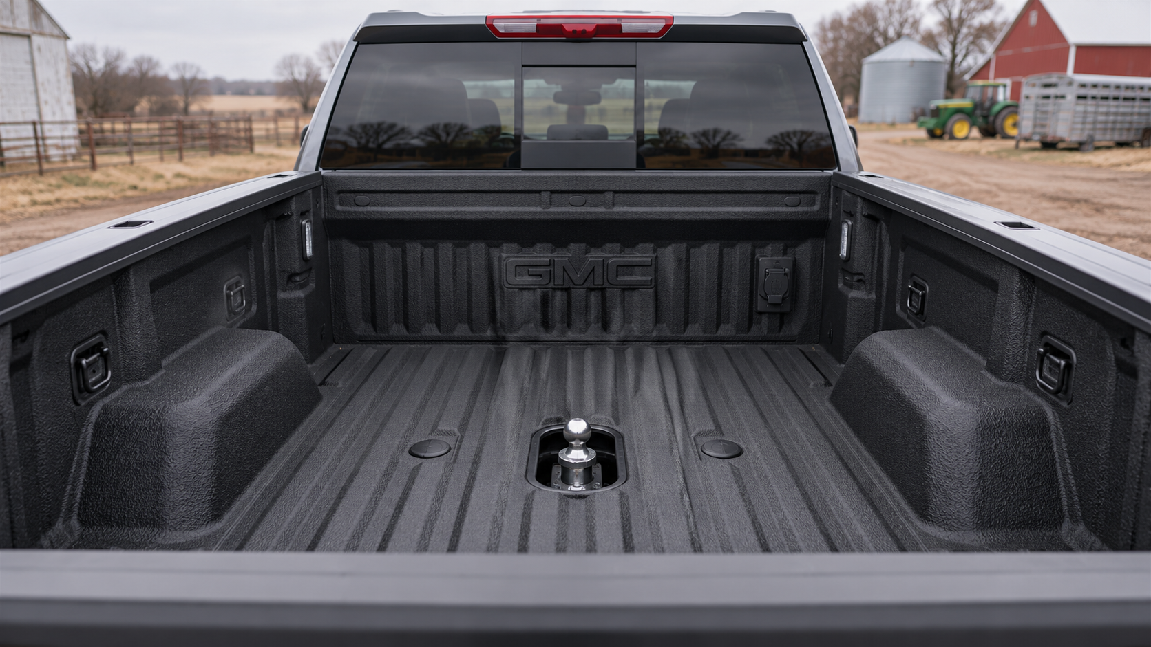 Gooseneck hitch tray, capped bed holes, and 7-pin connector in the bed of a 2026 GMC Sierra 2500 HD with the Max Trailering Package at Beadle Chevrolet GMC in Mobridge
