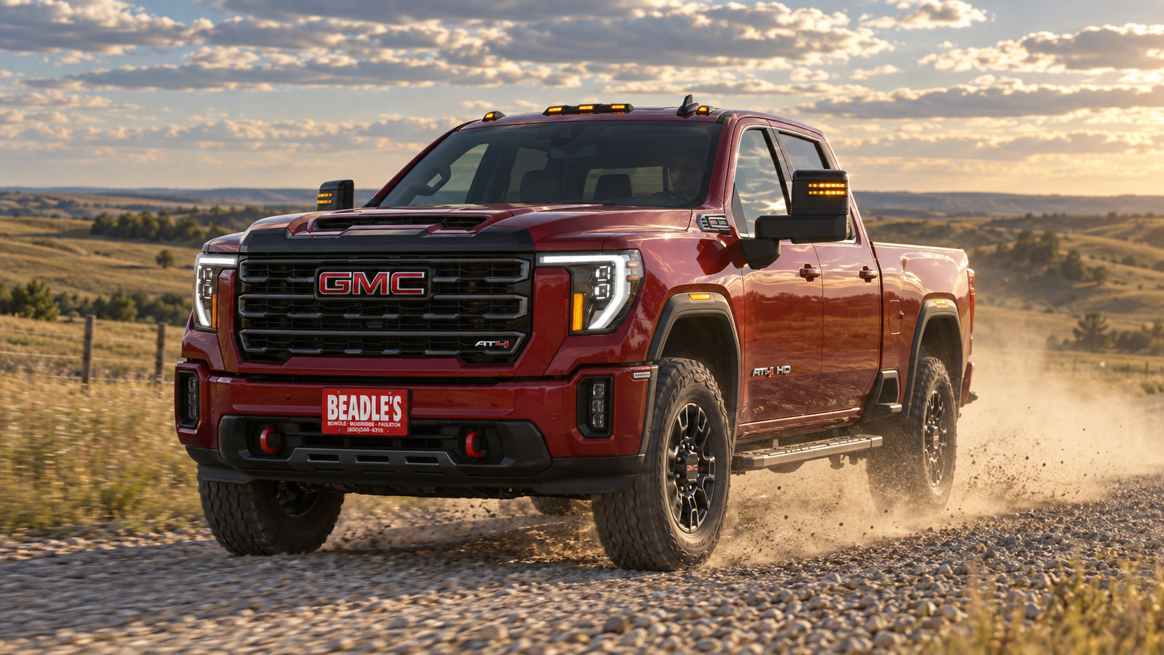 Volcanic Red 2026 GMC Sierra 2500 HD AT4 on a gravel section road near Mobridge, South Dakota